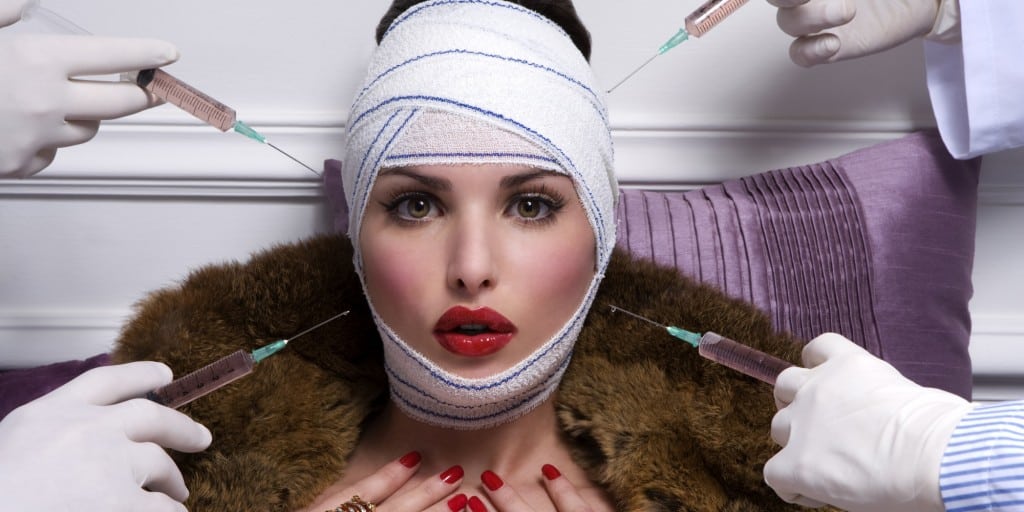 portrait of ayoung women with medical bandage and a fur-coat having a injection